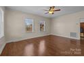 Bright living room with hardwood floors, complemented by natural light streaming through two large windows at 535 5Th St, Chester, SC 29706