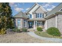 Brick front of house with welcoming porch and landscaping at 6057 Erie View Ct, Denver, NC 28037