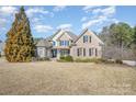 Brick two-story house with a large front yard and landscaping at 6057 Erie View Ct, Denver, NC 28037