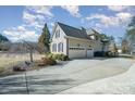 Two-car garage with driveway and landscaping at 6057 Erie View Ct, Denver, NC 28037