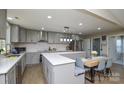 Spacious kitchen with island, gray cabinets, and breakfast nook at 6615 Love Mill Rd, Monroe, NC 28110