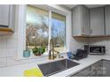 Modern kitchen sink with gold faucet and window overlooking backyard at 6615 Love Mill Rd, Monroe, NC 28110