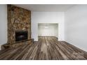 Bright living room with a large stone fireplace and hardwood floors at 7151 Stonington Ln, Charlotte, NC 28227