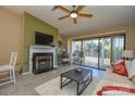 Living room with fireplace, hardwood floors, and access to balcony at 7608 Woods Ln # 12, Cornelius, NC 28031