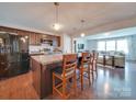 Modern kitchen with dark cabinets, island, stainless steel appliances, and open floor plan at 846 Von Buren Blvd, Rock Hill, SC 29730