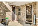 Inviting brick porch featuring a table, chair, and decorative elements, with a cozy ambiance for relaxing outdoors at 9428 Liberty Hill Dr, Mint Hill, NC 28227