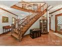 Elegant curved staircase with wooden railings in a spacious foyer at 955 Brafford Dr, Concord, NC 28025