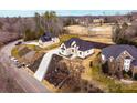 New construction home boasting brick and stone finishes, an immaculate lawn, and a winding driveway at 963 North Shore Dr, Hickory, NC 28601