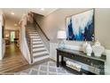Bright foyer featuring elegant staircase, console table with decor, and stylish rug at 102 Ellsworth Rd # 43, Mooresville, NC 28115