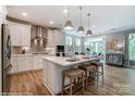 Bright kitchen with stainless steel appliances, quartz counters, an island with seating, and modern lighting at 102 Ellsworth Rd # 43, Mooresville, NC 28115