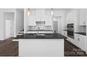 Open concept kitchen with a large center island, dark countertops, and stainless steel appliances at 3116 Beacon Heights Rd, Indian Land, SC 29707