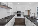 Modern kitchen features stainless steel appliances, gas cooktop, dark countertops, and white cabinetry at 3116 Beacon Heights Rd, Indian Land, SC 29707