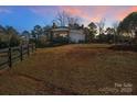 Spacious backyard with a home, fence, and alpacas at 3433 Grey Rd, Davidson, NC 28036