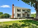 Two-story white house with brown shutters and a brick chimney; large tree in front at 3433 Grey Rd, Davidson, NC 28036