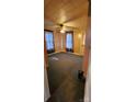 Bright bedroom with carpeted floors, ceiling fan, and two windows at 3706 2Nd Nw Ave, Hickory, NC 28601