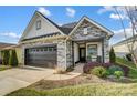 Charming ranch home with stone and white siding, plus a covered porch at 6257 Raven Rock Dr, Denver, NC 28037