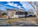 A backyard featuring a screened-in porch and a patio area perfect for outdoor living at 6305 Dale Ave, Charlotte, NC 28212