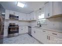 Bright kitchen featuring new appliances, stone countertops, and ample cabinet space at 6305 Dale Ave, Charlotte, NC 28212