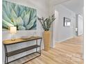 Beautiful foyer with light wood floors, modern decor, and a stylish console table at 8016 Brookbank Dr, Charlotte, NC 28269