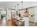 Stylish kitchen with white cabinets, stainless steel appliances, island with seating, and elegant backsplash at 128 Ballantree Rd # 46, Mooresville, NC 28115