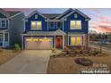 Two-story blue house with red door, neutral garage door, and landscaping at dusk at 14247 Canemeadow Dr, Charlotte, NC 28278