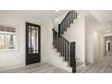 Inviting entryway with staircase, stylish front door, light floors, and modern finishes at 177 Olympia Dr, Mooresville, NC 28117