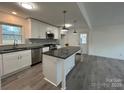 Modern kitchen featuring white cabinets, an island, and stainless steel appliances at 2334 Woodleaf Dr, Gastonia, NC 28052