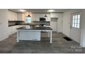 Modern kitchen featuring white cabinets, an island, and stainless steel appliances at 2334 Woodleaf Dr, Gastonia, NC 28052