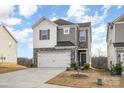 Two-story home with gray and white siding, stone accents, and a two-car garage at 345 Hyssop Ct, Fort Mill, SC 29715