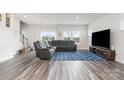 Spacious living room with gray sectional sofa and blue patterned rug at 345 Hyssop Ct, Fort Mill, SC 29715