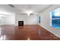Spacious living room featuring hardwood floors and a corner fireplace at 3522 Larkhaven Village Dr, Charlotte, NC 28215