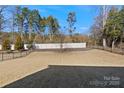 Expansive backyard featuring healthy turf, a well-maintained fence line, and mature trees at 857 Spelman Dr, Indian Land, SC 29707