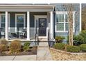 Front door entrance with columns, a porch, and well-manicured landscaping at 857 Spelman Dr, Indian Land, SC 29707