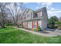 Gray two-story home with red shutters, attached garage, and well-manicured lawn at 10111 Grimsby Ct, Huntersville, NC 28078