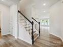 Stylish staircase with modern black and white railings leading to the upper level at 10117 Mamillion Dr, Huntersville, NC 28078