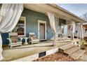 Inviting front porch with white rocking chairs and sheer curtains at 124 Piedmont St, Rock Hill, SC 29730