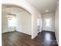 Bright entryway with hardwood floors, high ceilings, and an arched passage to the dining room at 127 Doncaster Dr, Mooresville, NC 28115