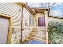 Front entrance with stone-clad exterior, wooden stairs, and a double door at 1419 Jules Ct, Charlotte, NC 28226