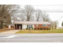 A charming red brick house with a metal roof and a well-manicured lawn at 1715 Emmanuel Church Rd, Conover, NC 28613