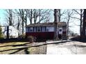 Ranch home with gray and red siding, steps, and a tree in the front yard at 1750 Oak Valley Dr, Gastonia, NC 28054