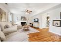 Living room with hardwood floors, fireplace, and neutral colored sectional sofa at 2012 Orby Ave, Indian Trail, NC 28079