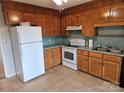 Galley style kitchen with wood cabinets and white appliances at 240 Pointe Cir # 240, Rock Hill, SC 29732