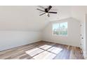 Bright bedroom with ceiling fan, large windows offering a scenic view, and wood-look flooring at 2906 Lathan Rd, Monroe, NC 28112