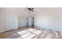 Spacious bedroom with vaulted ceiling, ceiling fan, two doors, and wood-look flooring at 2906 Lathan Rd, Monroe, NC 28112