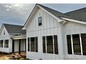 White farmhouse exterior with dark gray shutters and a gray roof at 2906 Lathan Rd, Monroe, NC 28112