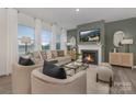 Cozy living room featuring a fireplace and large windows at 3016 Ora Smith Rd, Lincolnton, NC 28092