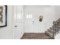 Bright entryway with hardwood floors, white doors, and a staircase leading upstairs at 3028 Ora Smith Rd, Lincolnton, NC 28092