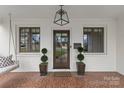 Close-up of the home's front porch, featuring a decorative door and hanging light fixture at 373 Hillside Ave, Charlotte, NC 28209