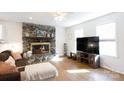 Living room with stone fireplace and large TV at 3988 Crestview Dr, Rock Hill, SC 29732