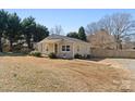 Quaint single-story home with a side yard, showcasing its cozy charm and inviting appeal at 413 Shinnville Rd, Mooresville, NC 28115